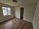 Cozy bedroom featuring wood-look floors and a large window at 10522 Riverside Rd, Port Charlotte, FL 33981