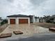 Stunning exterior view of a modern home with a two-car garage and brick paved driveway at 10522 Riverside Rd, Port Charlotte, FL 33981