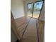 Bright room with wood-look tile and a large sliding glass door showcasing a scenic water view at 10522 Riverside Rd, Port Charlotte, FL 33981