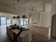 Bright, open-concept living room flows seamlessly from the kitchen and features modern lighting at 10522 Riverside Rd, Port Charlotte, FL 33981