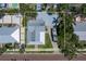 Aerial view of a yellow two-story house with a covered porch, surrounded by palm trees at 110 Gilchrist St, Punta Gorda, FL 33950