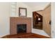 Attic access next to a brick fireplace in a bedroom; has exposed framing and plank floor at 110 Gilchrist St, Punta Gorda, FL 33950