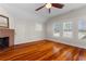 Spacious bedroom with hardwood floors, fireplace, and large windows at 110 Gilchrist St, Punta Gorda, FL 33950