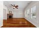 Bright bedroom with hardwood floors, fireplace, and an overhead ceiling fan at 110 Gilchrist St, Punta Gorda, FL 33950