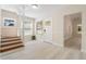 Inviting entryway with wood staircase, light hardwood floors, and natural light at 110 Gilchrist St, Punta Gorda, FL 33950