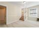 Light and airy entryway featuring wood staircase and neutral paint scheme at 110 Gilchrist St, Punta Gorda, FL 33950