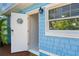 Blue and white shingle with a nautical front door and a large window with a view at 110 Gilchrist St, Punta Gorda, FL 33950