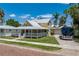 Charming two-story yellow home with a covered porch and a well-maintained lawn at 110 Gilchrist St, Punta Gorda, FL 33950