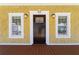 Close-up view of the front door, flanked by two windows, that offers an inviting entrance at 110 Gilchrist St, Punta Gorda, FL 33950