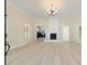 Open-concept living room with fireplace, light-colored floors and plenty of natural light at 110 Gilchrist St, Punta Gorda, FL 33950