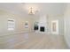Spacious living room featuring a fireplace, chandelier and beautiful light-colored laminate floors at 110 Gilchrist St, Punta Gorda, FL 33950