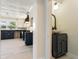 Stylish powder room located adjacent to the kitchen features black cabinet and decorative mirror at 110 Gilchrist St, Punta Gorda, FL 33950