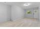 Room with wood-look tile floors, light gray walls, and a window with an exterior view at 110 Gilchrist St, Punta Gorda, FL 33950