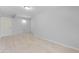 View of a room with wood-look tile floors, light gray walls, and a white door on the left at 110 Gilchrist St, Punta Gorda, FL 33950