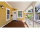 Inviting side porch perfect for relaxing in a private outdoor space with nice landscaping at 110 Gilchrist St, Punta Gorda, FL 33950