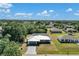 Aerial view of home showcasing its well-maintained yard, landscaping, and neighborhood at 1210 Marlow St, Port Charlotte, FL 33952
