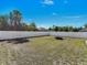 A large backyard with white fence and fire pit, ready for outdoor enjoyment at 1210 Marlow St, Port Charlotte, FL 33952