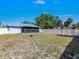 Spacious fenced backyard featuring a fire pit and covered lanai at 1210 Marlow St, Port Charlotte, FL 33952