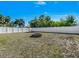 Fenced backyard featuring a simple fire pit and ample space for outdoor activities at 1210 Marlow St, Port Charlotte, FL 33952
