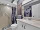 Clean and updated bathroom featuring a shower, neutral tiles, and a modern vanity at 1210 Marlow St, Port Charlotte, FL 33952