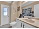 Cozy bathroom featuring a toilet, sink, and mirror at 1210 Marlow St, Port Charlotte, FL 33952