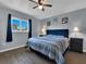 Bright bedroom with a large window, wood floors, and a ceiling fan at 1210 Marlow St, Port Charlotte, FL 33952