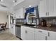 Well-appointed kitchen featuring white cabinets, stainless steel appliances, and modern fixtures at 1210 Marlow St, Port Charlotte, FL 33952