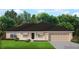 Charming single-story home with a two-car garage, well-manicured lawn, and a welcoming front porch at 13173 Gotham Ave, Port Charlotte, FL 33953