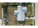 Aerial shot of the home showing roof, lawn, back patio, and proximity to other homes at 13449 Muriel Ave, Port Charlotte, FL 33981