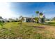 The ample backyard features flourishing greenery, lush green yard with palm trees creating a tranquil setting at 13449 Muriel Ave, Port Charlotte, FL 33981