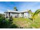 The outdoor space has a cute garden, charming decorations, and seating to relax and enjoy the fresh air at 13449 Muriel Ave, Port Charlotte, FL 33981