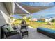 Outdoor patio area featuring comfortable seating, a fire pit, a grill, and a sun sail for shade at 13449 Muriel Ave, Port Charlotte, FL 33981