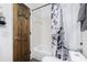 Updated bathroom with a shower and tub combination and dark wood door at 13449 Muriel Ave, Port Charlotte, FL 33981