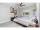 A neutral bedroom features modern decor, light-colored wood floors and natural light at 13449 Muriel Ave, Port Charlotte, FL 33981