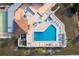 Overhead shot of a community pool with ample seating, shade, and lounge chairs at 13449 Muriel Ave, Port Charlotte, FL 33981