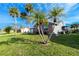 This lovely home has vibrant green yard with lush palm trees creating a tranquil setting at 13449 Muriel Ave, Port Charlotte, FL 33981