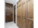 Hallway featuring wood paneled closet doors and tile flooring at 13449 Muriel Ave, Port Charlotte, FL 33981