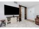 The gorgeous living room has a large TV, charming sliding barn door, and stylish furnishings at 13449 Muriel Ave, Port Charlotte, FL 33981