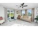 Sunroom with a sliding glass door leading to the backyard and comfortable seating at 13449 Muriel Ave, Port Charlotte, FL 33981