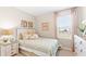 Comfortable bedroom featuring coastal decor and a large window for natural light at 1419 Powell Valley Dr, Port Charlotte, FL 33953