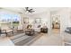 Bright living room featuring an oversized window, ceiling fan, modern furniture, and stylish decor at 1419 Powell Valley Dr, Port Charlotte, FL 33953