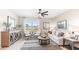 Bright living room featuring an oversized window, ceiling fan, modern furniture, and stylish decor at 1419 Powell Valley Dr, Port Charlotte, FL 33953