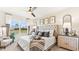 Well-lit main bedroom with large window, ceiling fan, stylish decor, and comfortable furniture at 1419 Powell Valley Dr, Port Charlotte, FL 33953