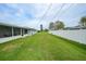 Spacious backyard enclosed with a white fence at 1756 Elinor Pl, Englewood, FL 34223