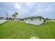 View of a large, fenced backyard and the side of the house at 1756 Elinor Pl, Englewood, FL 34223