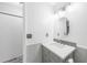 Bright bathroom featuring a vanity with gray cabinets, framed mirror, and shower at 1756 Elinor Pl, Englewood, FL 34223