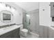 Bathroom with glass-door shower, modern vanity, and hexagon tile floor at 1756 Elinor Pl, Englewood, FL 34223