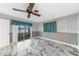 Bedroom with tiled floors, fan, and sliding glass doors leading to sun room at 1756 Elinor Pl, Englewood, FL 34223