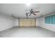 Spacious two car garage with ceiling fan and automatic door at 1756 Elinor Pl, Englewood, FL 34223