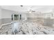 Spacious living room featuring large windows and a decorative ceiling fan at 1756 Elinor Pl, Englewood, FL 34223